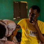 Image of optometrist Melakmu Yitayew, wearing a yellow Light for the World t-shirt, testing the eyes of pupil Senayet Bashura at Sikela Primary School in Arba Minch, Ethiopia. Melakmu works at Arba Minch Hospital Secondary Eye Care Unit, an implementing partner of the 1, 2, 3 I can see! programme, which focuses on child eye health. ©Lidya Alemayehu/Light for the World.