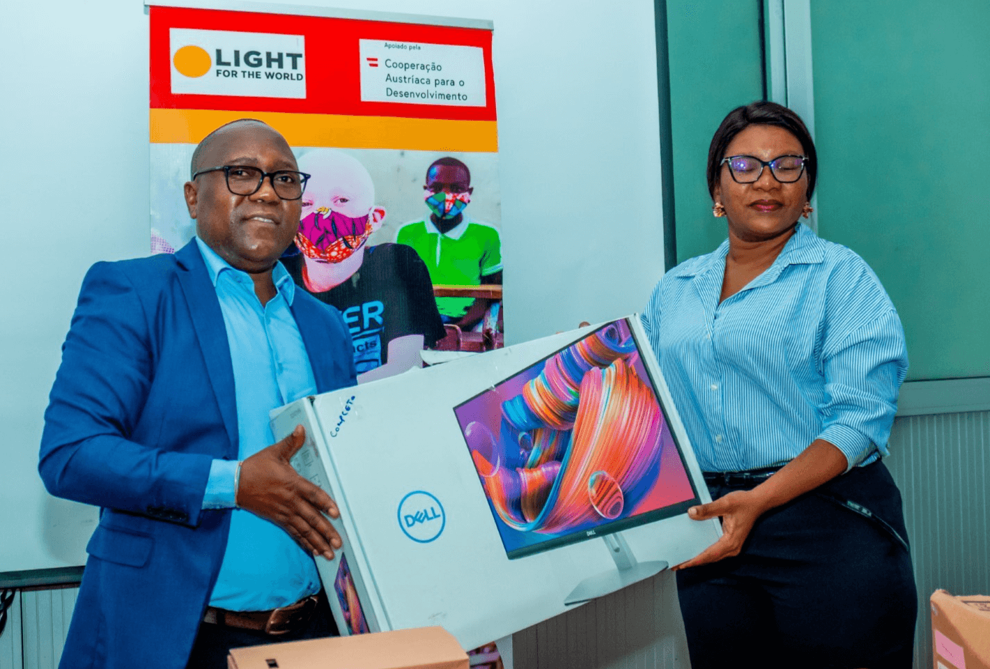 Light for the World Country Director Zacarias Zicai hands over computer equipment donations to the Provincial Director of Education, Dilza Gotine.