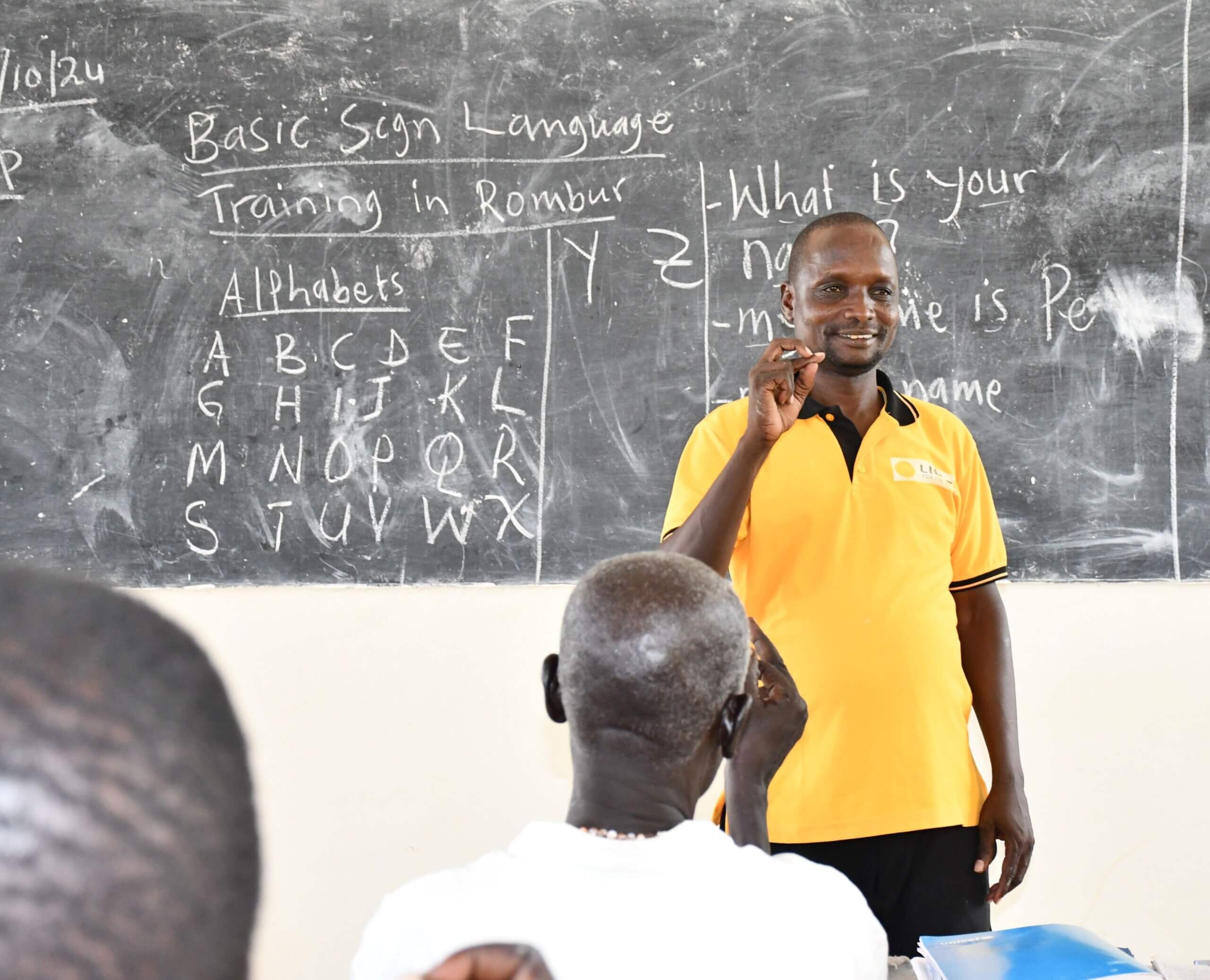 Peter Kachinga, a Disability Inclusion Facilitator, delivers training for student teachers in a classroom.