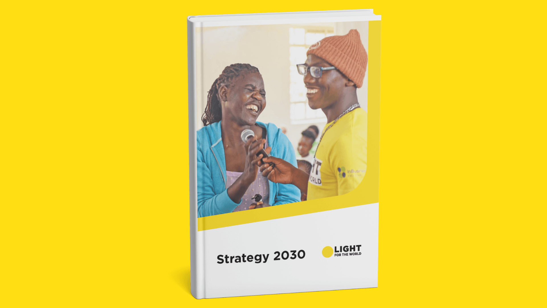 Mock-up photo of Light for the World's Strategy 2030 document on a yellow background.