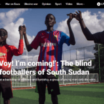 A screenshot from an Al Jazeera article about blind football in South Sudan. The image features two blind players raising hands with their coach. The headline is: Voy! I’m coming!’: The blind footballers of South Sudan.