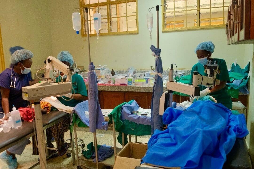 Ophthalmologists and health care workers performing eye surgeries in Uganda.